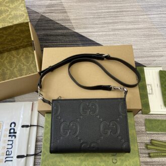 Gucci clutch with decorative strap Model:795240. Size: 15(L) x 22(W) x 4.5cm(D) Color: Black/embossed G original leather.