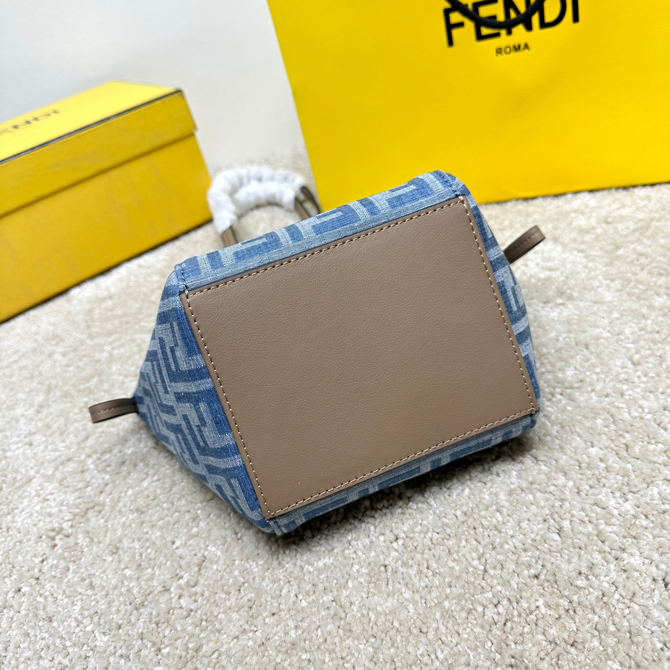 Medium-sized Origami handbag, imitation denim light blue fabric material, decorated with FF pattern. This style is designed with a deformable and innovative design to highlight the double-sidedness and creativity of FENDI: it is equipped with a flexible mechanism composed of 8 magnetic buckles, which can be folded into an origami-style bucket bag. When the magnets are all attracted to the magnetic buckle in the middle, gently pull the leather tie on the short shoulder straps on both sides and turn into a tote bag. It comes with a key ring hanger with metal FENDI lettering and beige leather details. Lined interior compartment with gold finish metal piece. Leather dual handle design for hand or shoulder. Size: 15×15×18.5cm Model: 9918 denim - Image 5